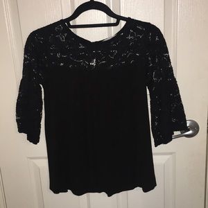 A black lace flare sleeve shirt.